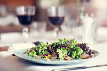 Couple eating romantic Dinner in a gourmet restaurant drinking wine and eating