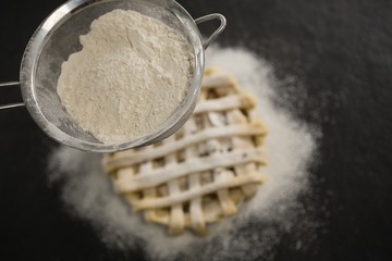 Close up of strainer over pie