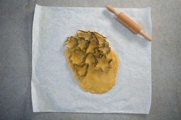 Directly above shot of various shape pastry cutter on rolled