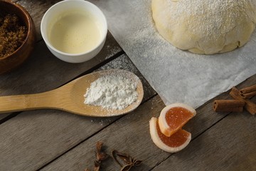 High angle view of ingredients by kneaded dough