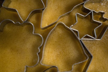 Overhead view of pastry cutters on dough