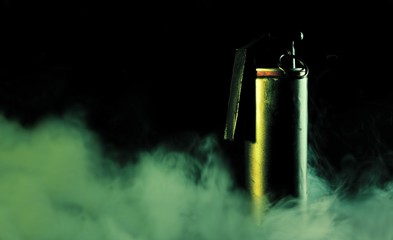 Smoke grenade on dark background with smoke
