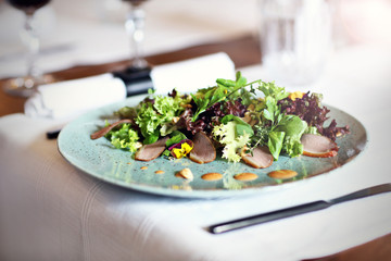 Couple eating romantic Dinner in a gourmet restaurant drinking wine and eating
