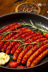 Wiener Sausages in a pan on wooden background