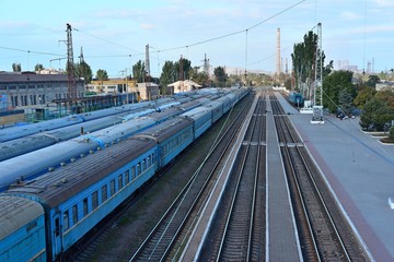 Obraz premium Railway station on the background of blue sky at sunrise with motion blur effect in vintage style. Railroad in Ukraine.