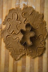 Close up of gingerbread man pastry cutter on dough