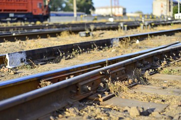 Railway station on the background of blue sky at sunrise with motion blur effect in vintage style. Railroad in Ukraine.