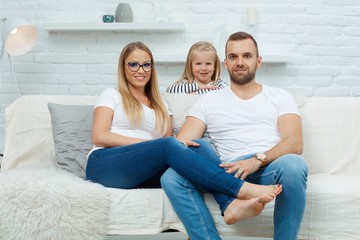 Obraz premium Happy family sitting on couch at home
