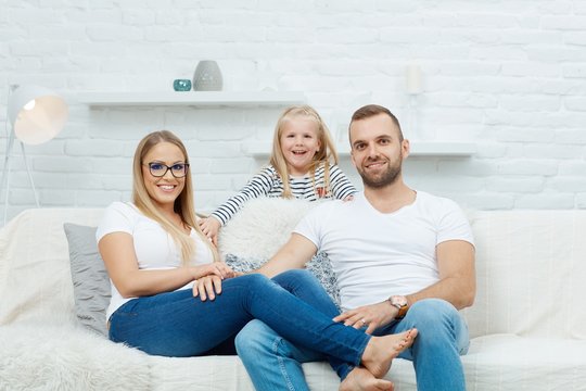 Happy family sitting on couch at home