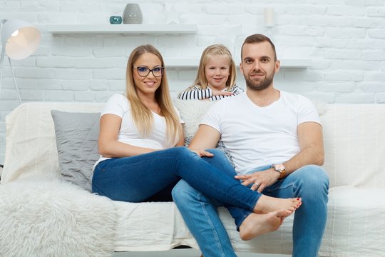 Happy family sitting on couch at home