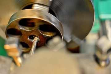 Professional machinist. Horizontal shot of a man operating lathe grinding machine metalworking industry concept copyspace