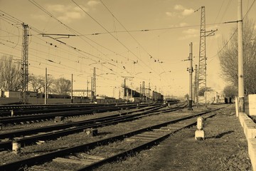 Fototapeta na wymiar Railway station on the background of blue sky at sunrise with motion blur effect in vintage style. Railroad in Ukraine.