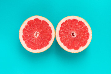 Grapefruit cut in half on a blue background