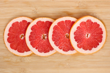 Sliced grapefruit on a wooden plank