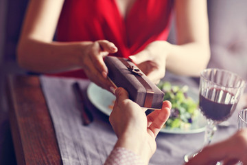 Midsection of romantic couple dating in restaurant