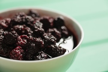 Close up of raspberry with syrup in bowl