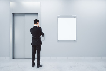 Man with poster and elevator