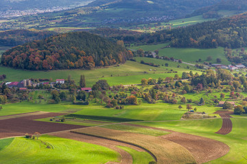 a aerial view from a mountain on a german green countryside with forest