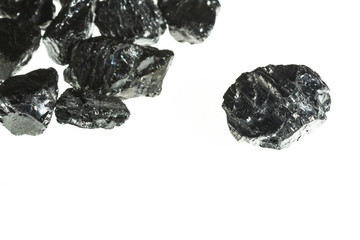 Black coal mine close-up with large depth of field. Anthracite coal bar isolated on white background