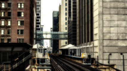 Obraz na płótnie Canvas Train on elevated tracks within buildings at the Loop, Chicago City Center - Sepia Glow Artistic Effect - Chicago, Illinois, USA
