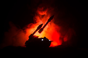 Fototapeta premium Rocket launch with fire clouds. Battle scene with rocket Missiles with Warhead Aimed at Gloomy Sky at night. Rocket vehicle on War Backgound.