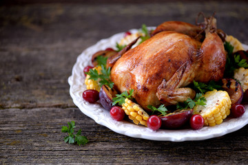 Grilled chicken on Thanksgiving day with corn, plum, dogwood and parsley.