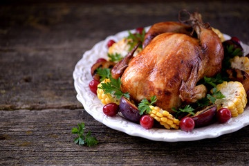 Grilled chicken on Thanksgiving day with corn, plum, dogwood and parsley.