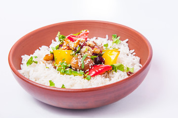 Chinese chicken sweet and sour sauce, served with rice and vegetables in the ceramic bowl on the white background isolated. Selective focus