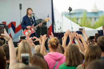 Audience cheering musicians at an open air music festival