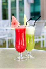 Cocktail glasses with hotel view.