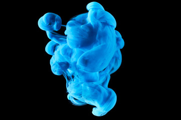 ink in the water. A splash of blue  paint. Abstract background color mixing