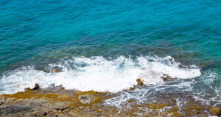 Tropical warm water of Caribbean sea with transparent sea bottom and rocks. Antigua, Caribbean island 
