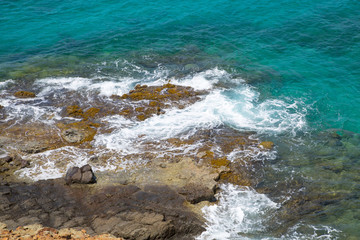 Tropical warm water of Caribbean sea with transparent sea bottom and rocks. Antigua, Caribbean island 