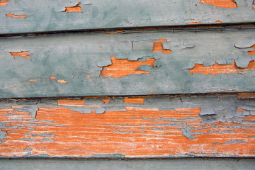 old orange cracked paint on wood background
