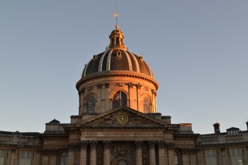 Fototapeta na wymiar Institute of France (Institut de France) from Paris, majestic cultural landmark and building of French Academy, at sunset