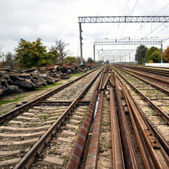 Fototapeta na wymiar Old abandoned railway, broken rails, broken sleepers