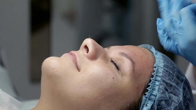 In the beauty salon the beautician makes the client a mechanical face cleaning