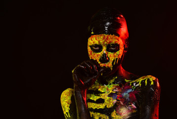 Halloween girl with skull face paint on black background