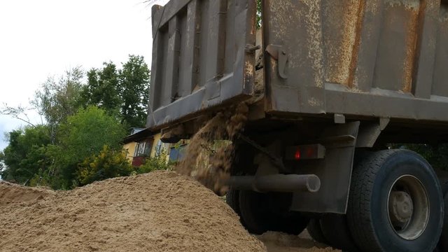 Dump truck unloading sand