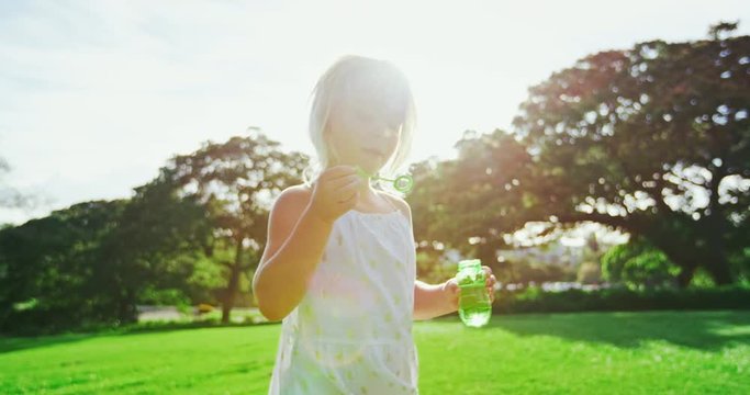 Young Girl Blowing Bubbles