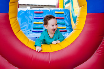 Fototapeta na wymiar Happy toddler peeking on trampoline