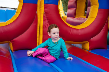 Fototapeta na wymiar Toddler kid stopped in the game of bounce