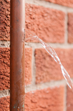 Water Coming Out Of A Burst Copper Water Pipe Which Had Been Broken By Freezing Ice.