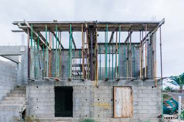 Scaffolding poles hold up shuttering for a concrete roof to be poured in a building site