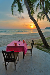 table and chairs on a tropical beach