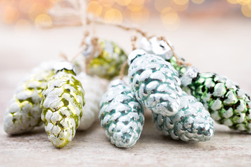 Christmas cone with red berries on a bokeh background.