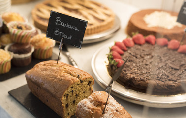 Plumcake in the foreground in a showcase of sweets