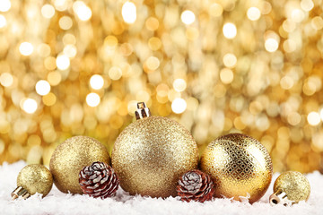Christmas baubles with cones on bokeh background