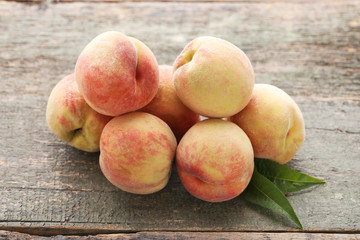 Ripe peaches fruit on grey wooden table