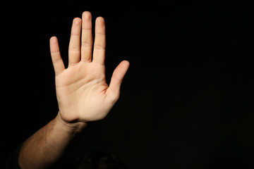 Male hand on a black background